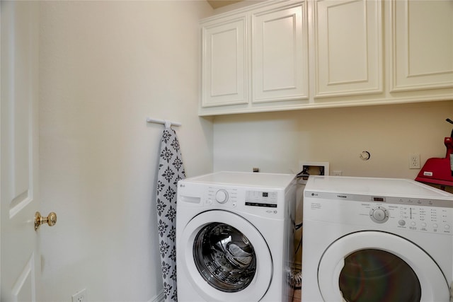 washroom featuring cabinet space and washing machine and dryer