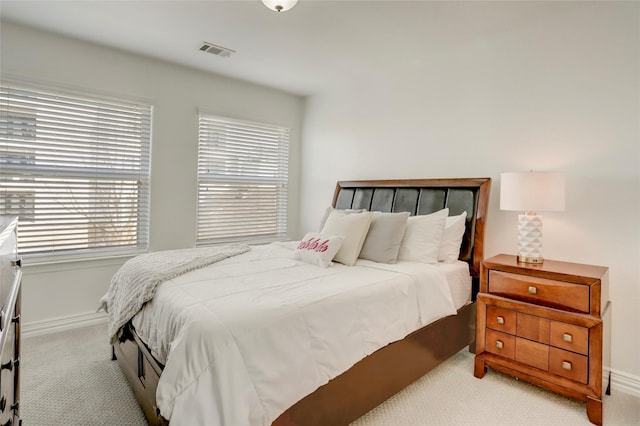 bedroom with carpet, visible vents, and baseboards