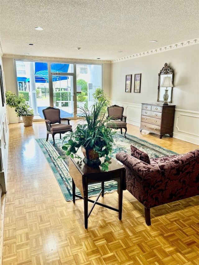 interior space featuring a wainscoted wall, a decorative wall, and a textured ceiling