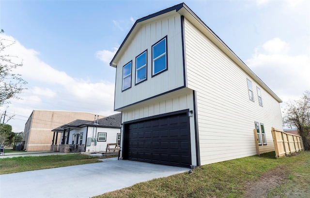 view of property exterior featuring driveway, an attached garage, and board and batten siding