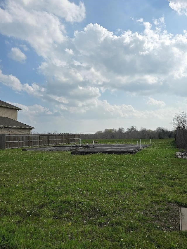 view of yard featuring a rural view and fence