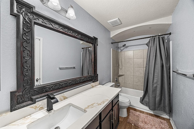 15307 Meandering Post Trl, Houston, TX 77044 - bathroom with vanity, toilet, shower / bath combination with curtain, a textured wall, and a textured ceiling