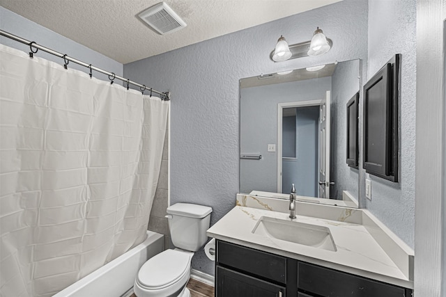 15307 Meandering Post Trl, Houston, TX 77044 - full bathroom with a textured wall, vanity, toilet, a textured ceiling, and shower / bath combo
