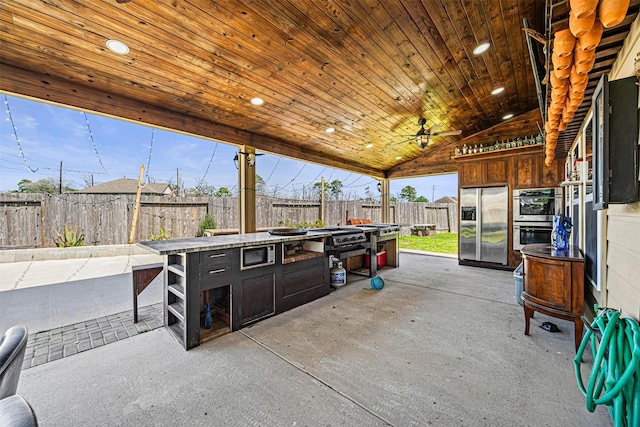 15307 Meandering Post Trl, Houston, TX 77044 - fenced backyard with exterior kitchen and a patio area