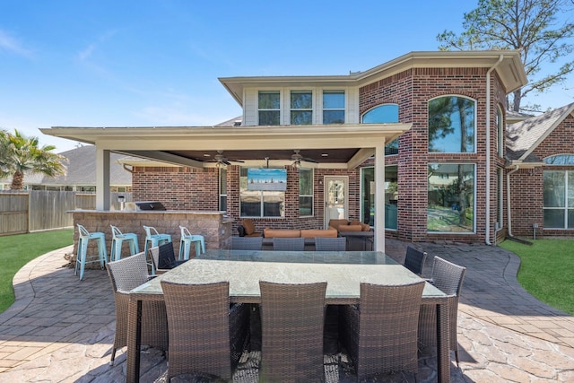 view of patio / terrace with a ceiling fan, outdoor dining space, fence, and area for grilling