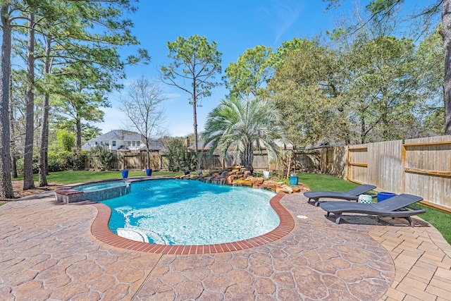 view of pool featuring a fenced backyard, a pool with connected hot tub, and a patio