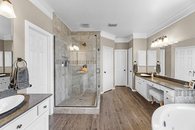 bathroom with a shower stall, ornamental molding, a sink, and wood finished floors