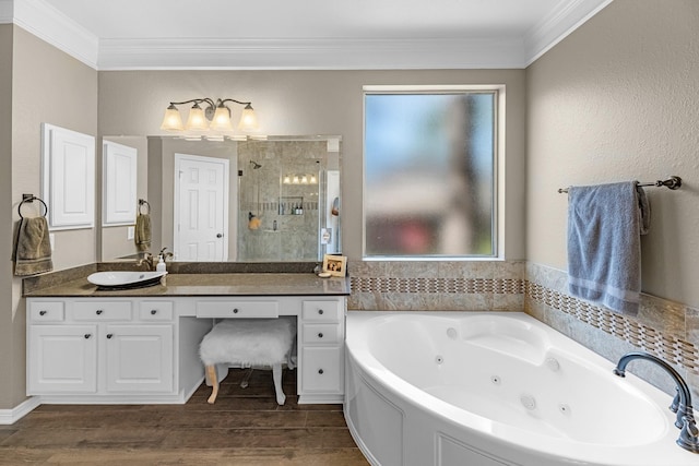 full bath featuring ornamental molding, a shower stall, vanity, wood finished floors, and a jetted tub