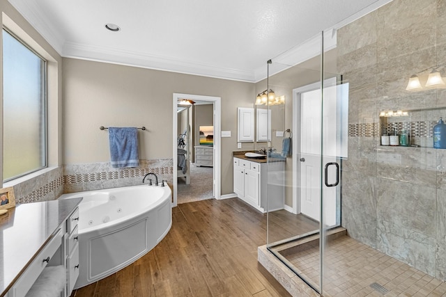 full bathroom featuring ornamental molding, a stall shower, vanity, plenty of natural light, and a whirlpool tub