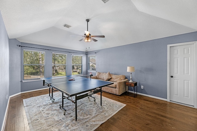 recreation room featuring wood-type flooring, vaulted ceiling, a textured ceiling, and baseboards