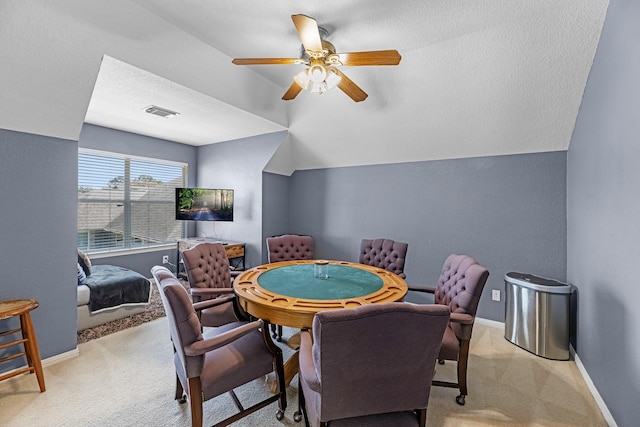 recreation room featuring lofted ceiling, carpet floors, a ceiling fan, visible vents, and baseboards