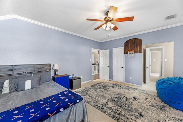 bedroom with carpet floors, visible vents, crown molding, and baseboards