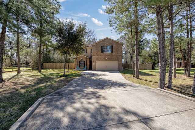 traditional-style home with brick siding, a front yard, fence, a garage, and driveway