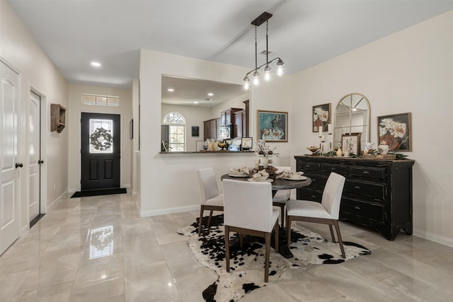 dining room with recessed lighting and baseboards