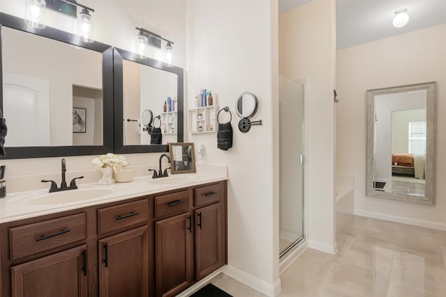 bathroom featuring double vanity, a stall shower, ensuite bath, and a sink