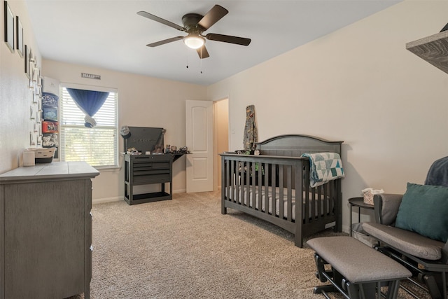 bedroom with baseboards, a ceiling fan, and light colored carpet