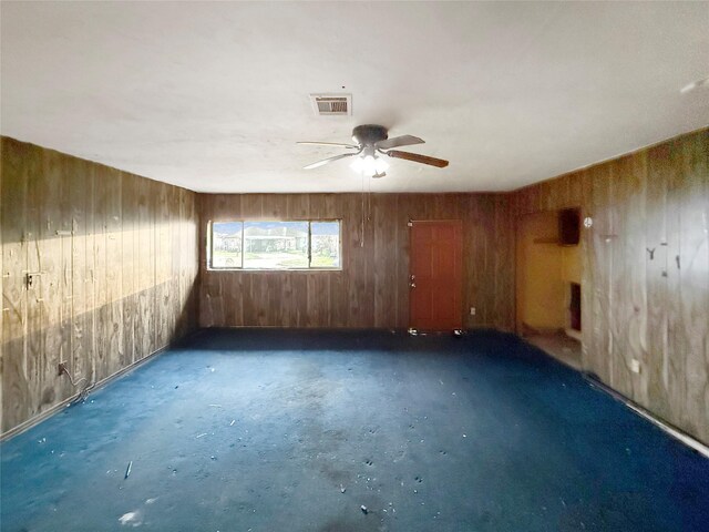 8611 Sunmoore Ct, Houston, TX 77088 - unfurnished room with ceiling fan, wood walls, and visible vents