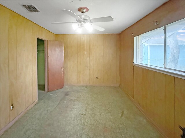 8611 Sunmoore Ct, Houston, TX 77088 - empty room with ceiling fan, wood walls, and visible vents