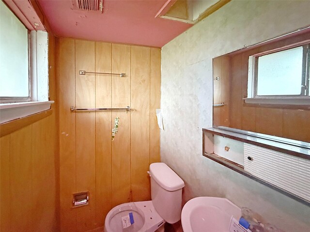 8611 Sunmoore Ct, Houston, TX 77088 - half bath featuring toilet, wood walls, and visible vents