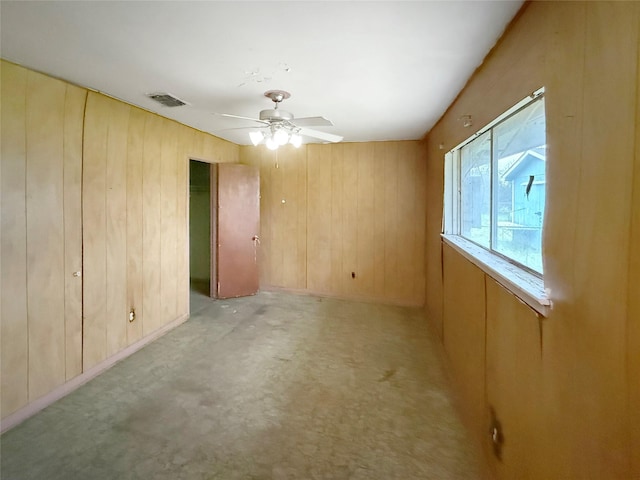 8611 Sunmoore Ct, Houston, TX 77088 - spare room featuring visible vents, ceiling fan, and wooden walls