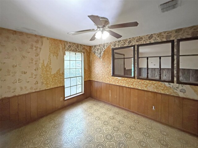 8611 Sunmoore Ct, Houston, TX 77088 - spare room with a ceiling fan, a wainscoted wall, visible vents, and wallpapered walls