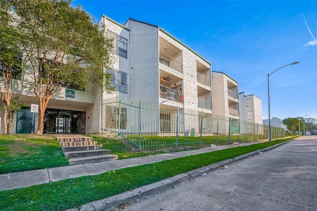 view of building exterior featuring fence