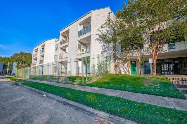 view of building exterior featuring fence