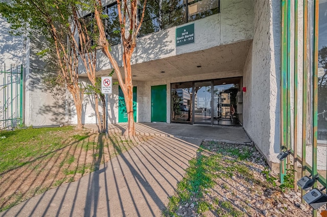 doorway to property with stucco siding