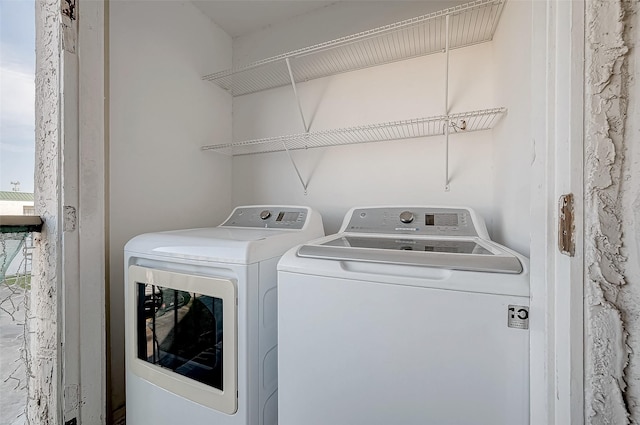 clothes washing area with washer and dryer and laundry area