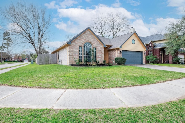 view of front of house with driveway, a chimney, fence, a front lawn, and brick siding