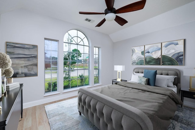 bedroom featuring lofted ceiling, a ceiling fan, baseboards, visible vents, and light wood-style floors