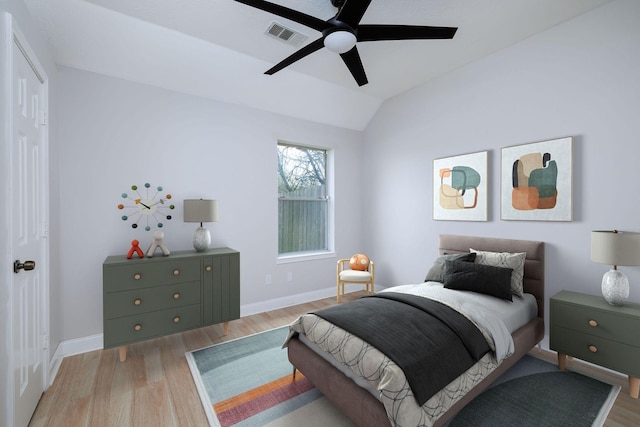 bedroom featuring vaulted ceiling, baseboards, and light wood-style floors