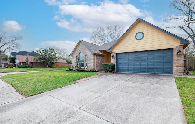 view of front of property with brick siding, an attached garage, a front yard, fence, and driveway