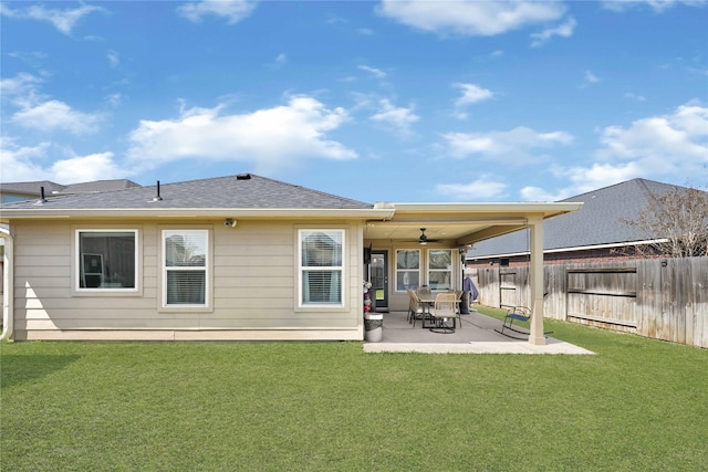 rear view of house featuring a patio, a yard, a fenced backyard, and ceiling fan