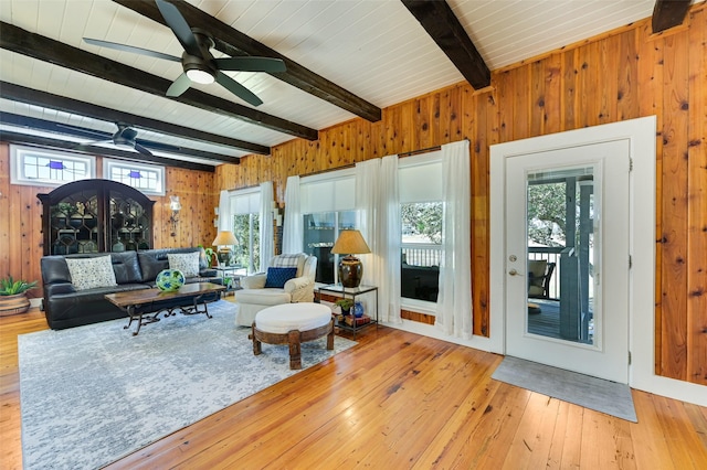 206 County Road 142, Burnet, TX 78611 - living room with wooden ceiling, wood walls, a ceiling fan, beam ceiling, and wood-type flooring