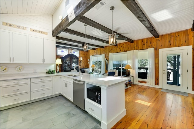 206 County Road 142, Burnet, TX 78611 - kitchen with black microwave, a peninsula, a sink, open floor plan, and stainless steel dishwasher