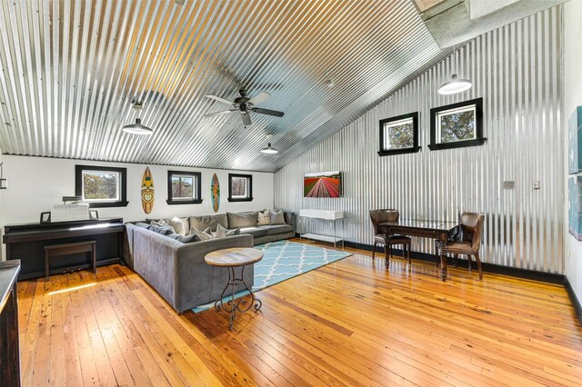 206 County Road 142, Burnet, TX 78611 - living room featuring wood-type flooring, metal wall, vaulted ceiling, and a ceiling fan