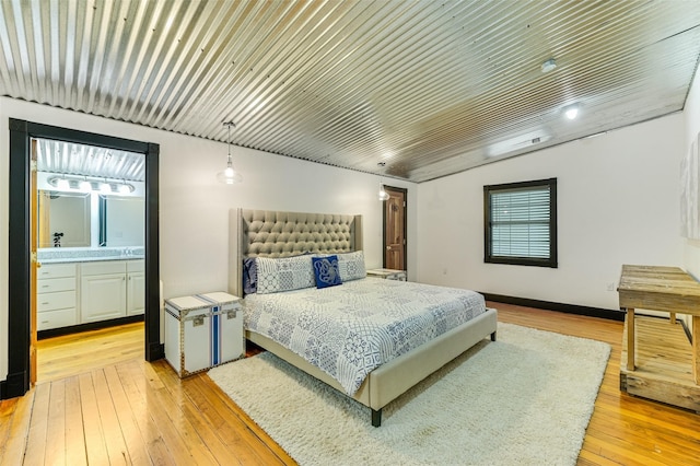206 County Road 142, Burnet, TX 78611 - bedroom featuring ensuite bathroom and light wood finished floors