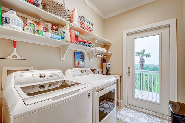 laundry area featuring laundry area, washer and clothes dryer, and crown molding