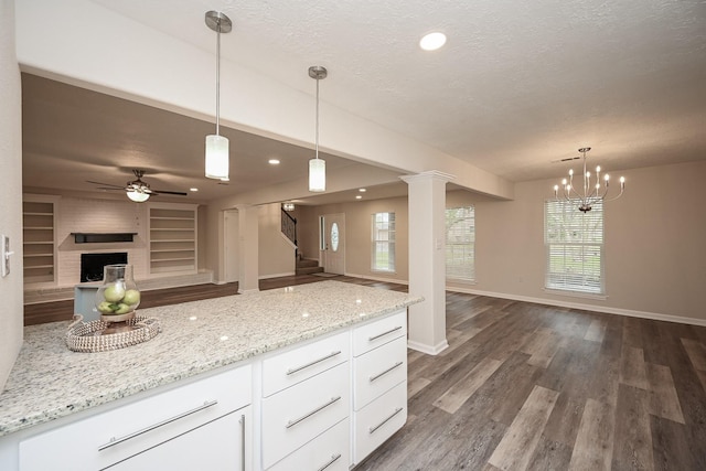 kitchen featuring dark wood-style floors, open floor plan, and a textured ceiling