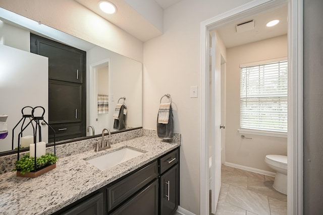 bathroom with visible vents, baseboards, toilet, marble finish floor, and vanity