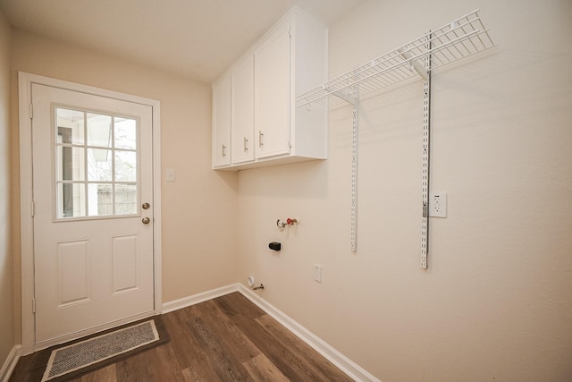 laundry room with hookup for a washing machine, visible vents, baseboards, cabinet space, and dark wood-style floors