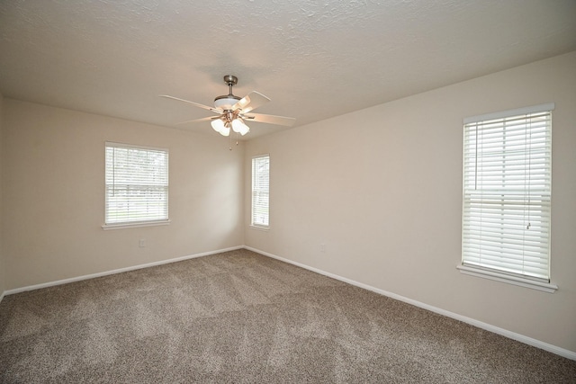 spare room featuring a ceiling fan, carpet, baseboards, and a textured ceiling