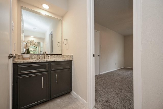 bathroom with vanity and baseboards