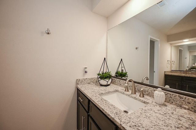 bathroom featuring visible vents and vanity