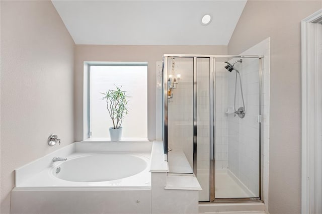 full bathroom featuring lofted ceiling, a garden tub, and a shower stall