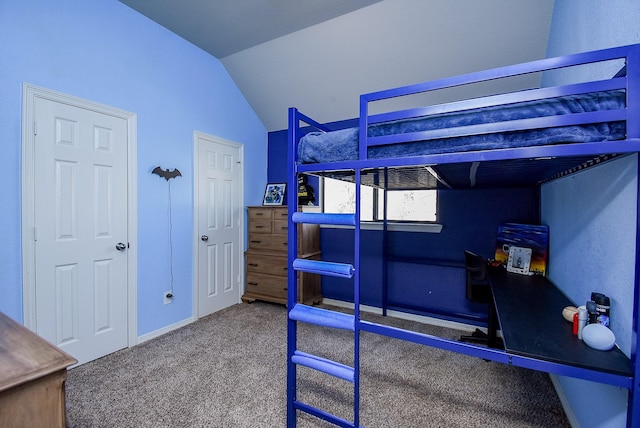 bedroom with lofted ceiling and carpet floors