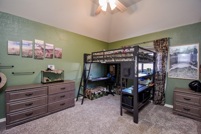 carpeted bedroom with a textured wall, a ceiling fan, and baseboards