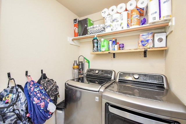 washroom featuring laundry area and washing machine and clothes dryer