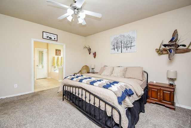 bedroom featuring ceiling fan, light tile patterned flooring, connected bathroom, light colored carpet, and baseboards